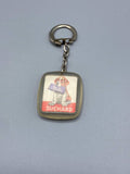 Porte-clés publicitaire Suchard – Chiot Saint-Bernard et tablette Milka