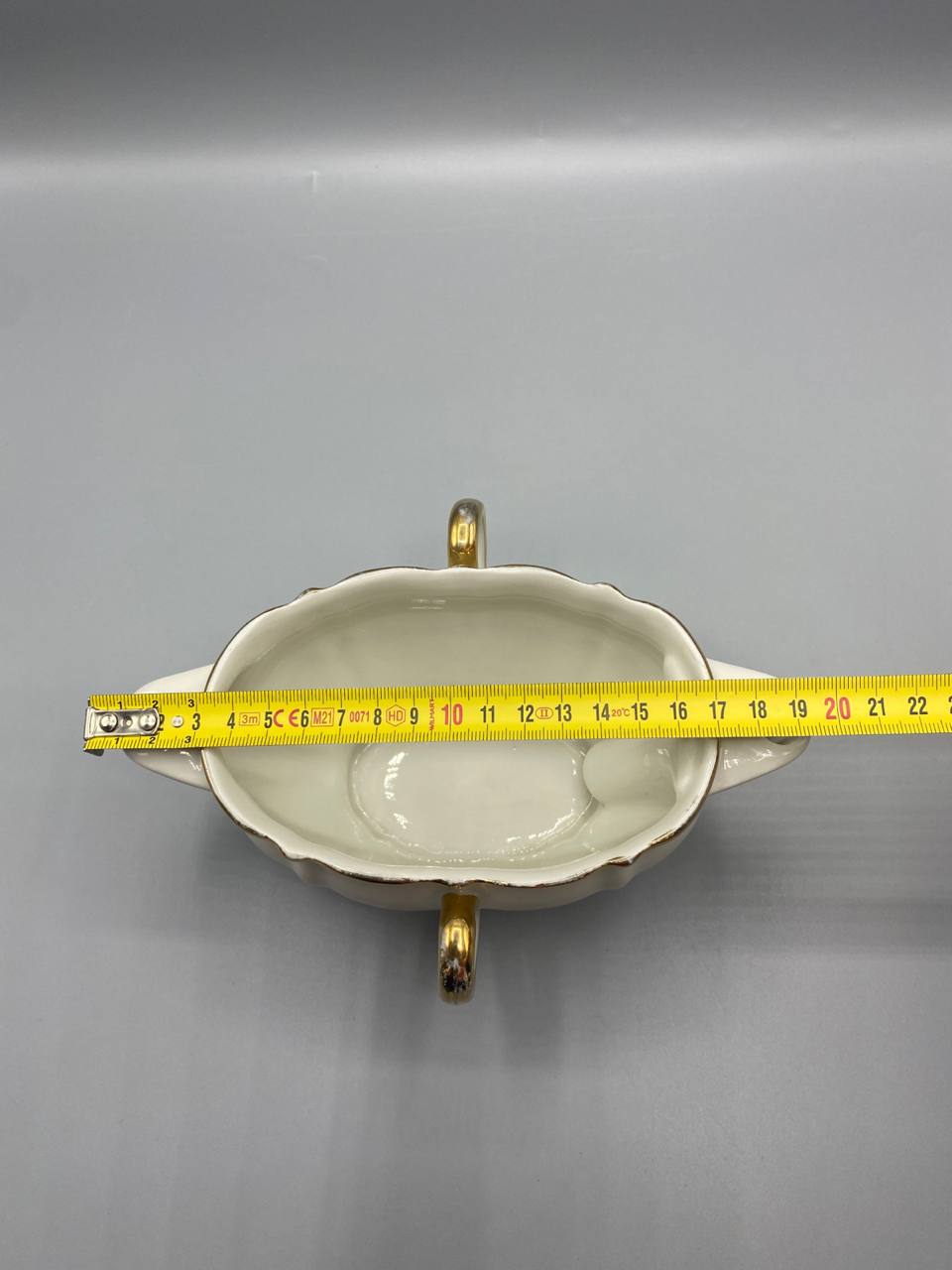 Vue de dessus saucière porcelaine blanche mesure longueur hors tout environ 20 cm mètre visible