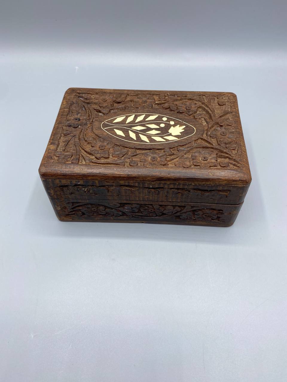 Boîte bois sheesham sculpté médaillon ovale incrustation os rinceaux feuillages fermée vue de trois quarts
