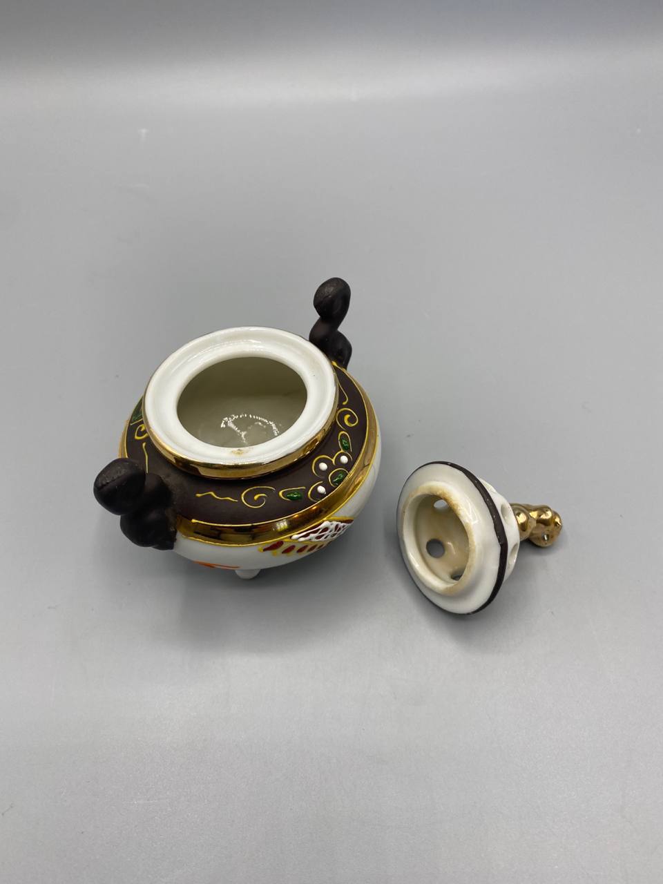 Brûle-parfum ouvert, corps intérieur émaillé crème, couvercle retourné avec perforations et Shishi doré, cachet illisible visible