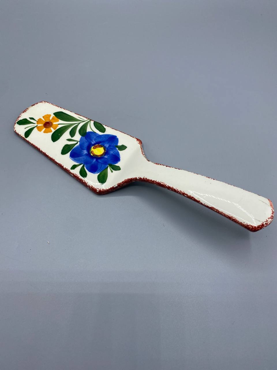 Pelle à tarte faïence, vue de face, décor floral bleu et jaune