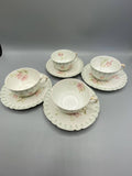 4 tasses et sous-tasses Jean Pouyat Limoges – vue d'ensemble, décor floral pastel Belle Époque
