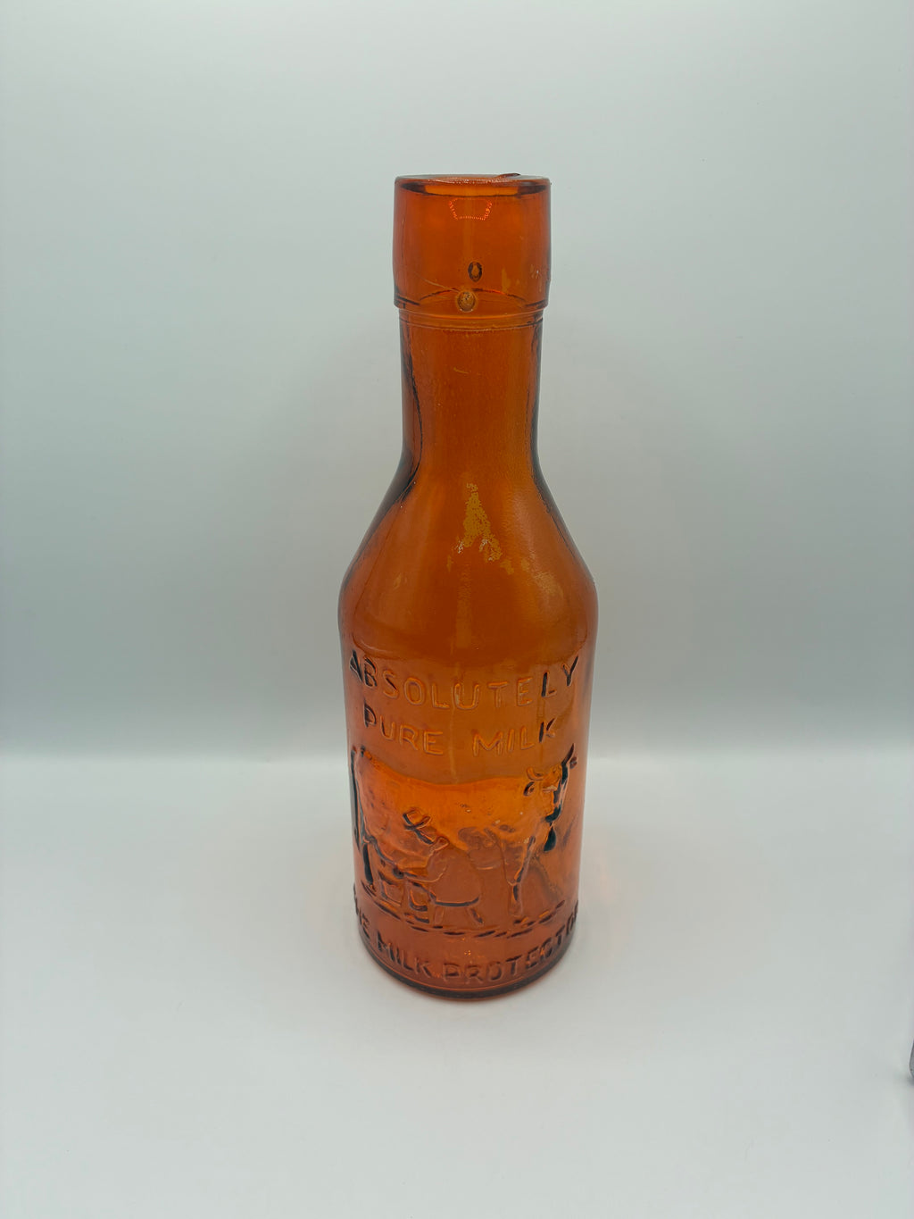 Ancienne bouteille à lait ambrée « Absolutely Pure Milk » – The Milk Protector – vers 1900