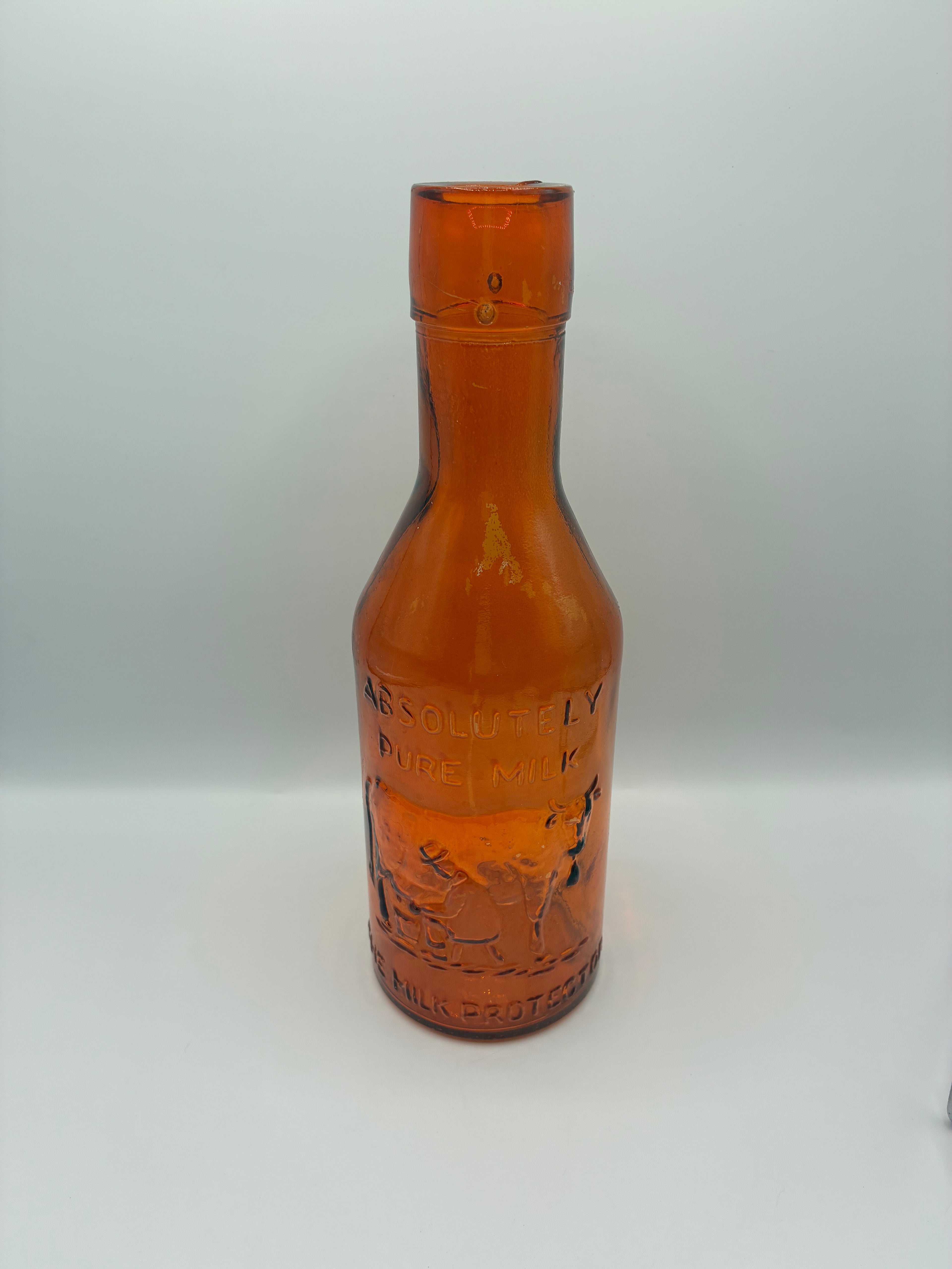 Ancienne bouteille à lait ambrée « Absolutely Pure Milk » – The Milk Protector – vers 1900