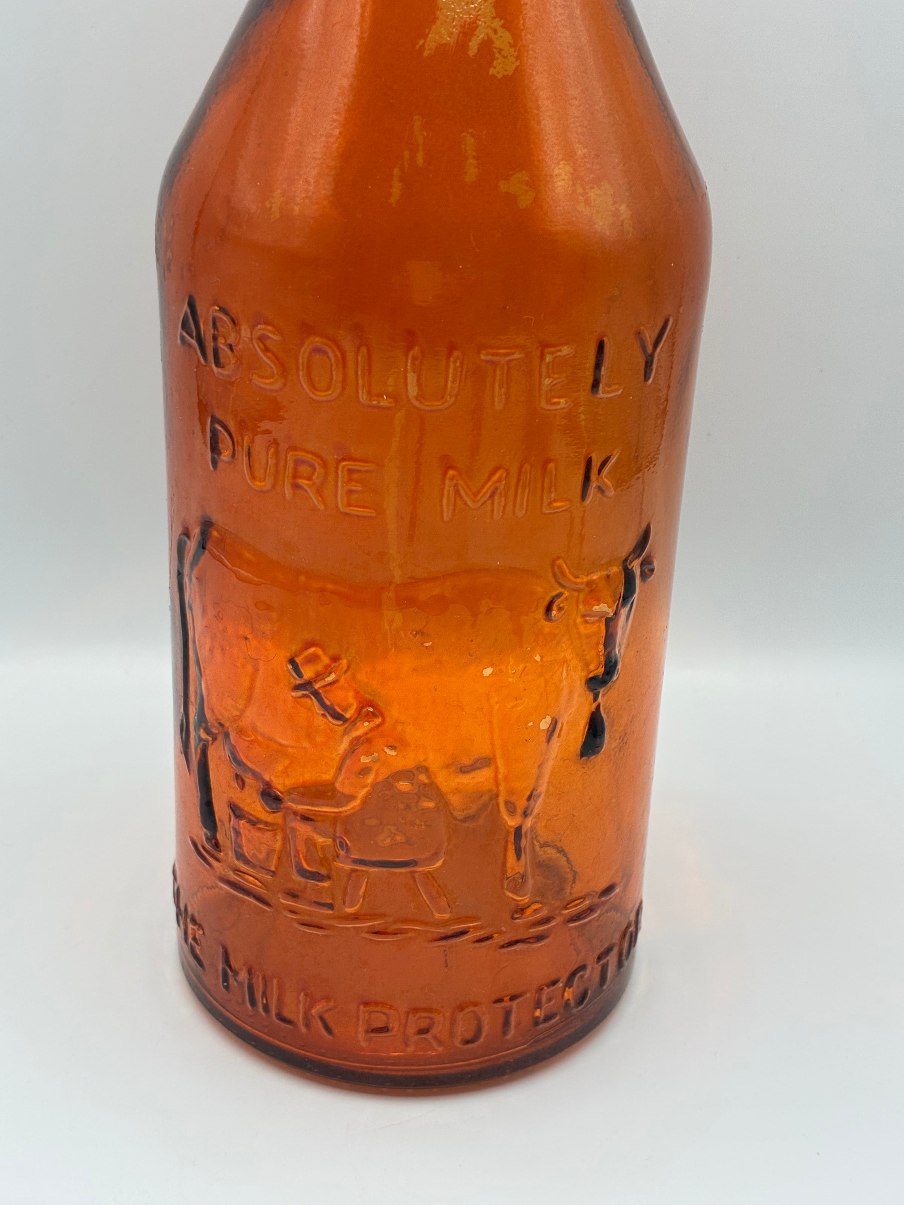 Ancienne bouteille à lait ambrée « Absolutely Pure Milk » – The Milk Protector – vers 1900