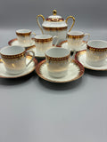 Ensemble à café en porcelaine blanche à décor pourpre et doré avec six tasses, soucoupes et sucrier