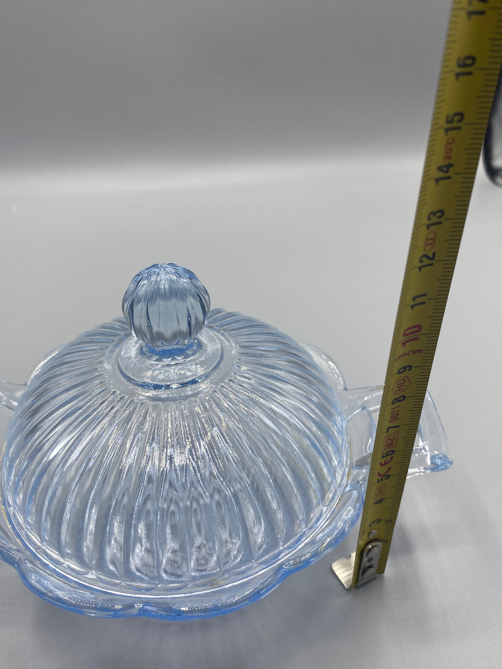 Bonbonnière verre bleu lavande de profil avec mètre, hauteur couvercle fermé environ 12 cm