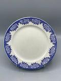 Assiette plate Digoin Sarreguemines modèle Capri, couronne de fleurs stylisées bleu cobalt sur fond blanc, frise losanges