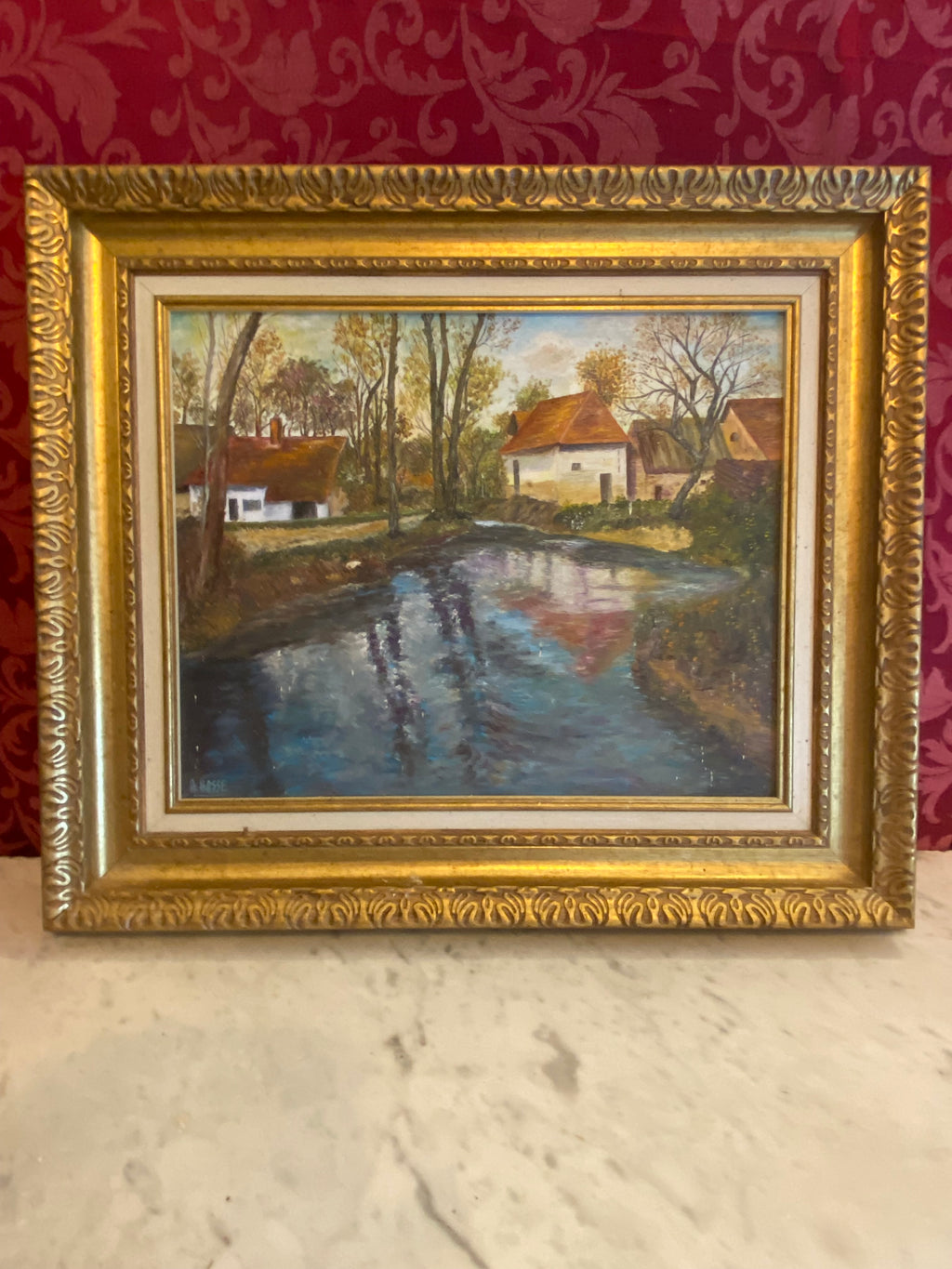 Huile sur toile attribuée André Hasse, paysage fluvial automnal, maisons blanches toiture rousse, reflets dans l'eau