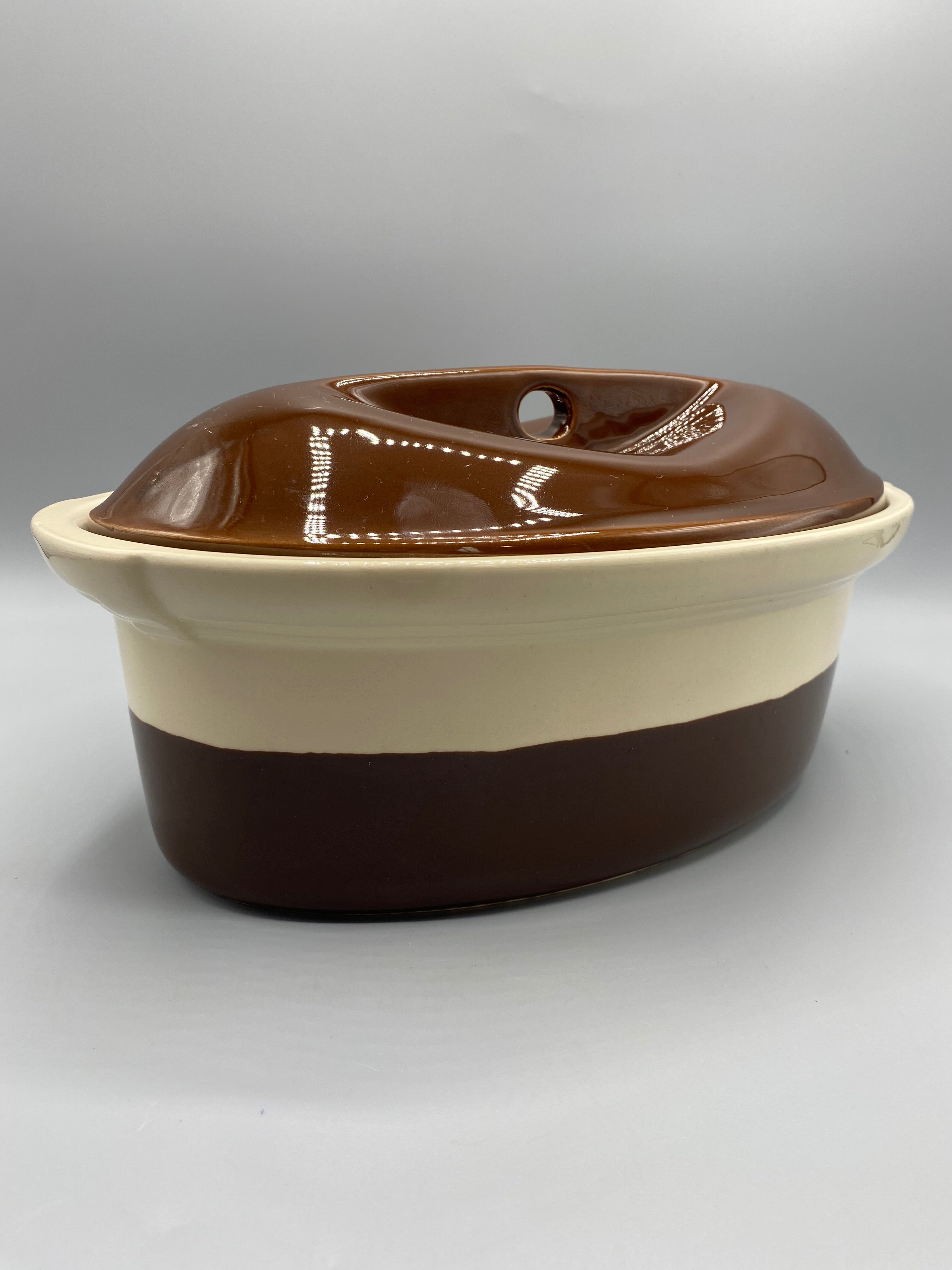 Terrine ovale Émile Henry – Vue couvercle ouvert, intérieur crème et couvercle brun chocolat