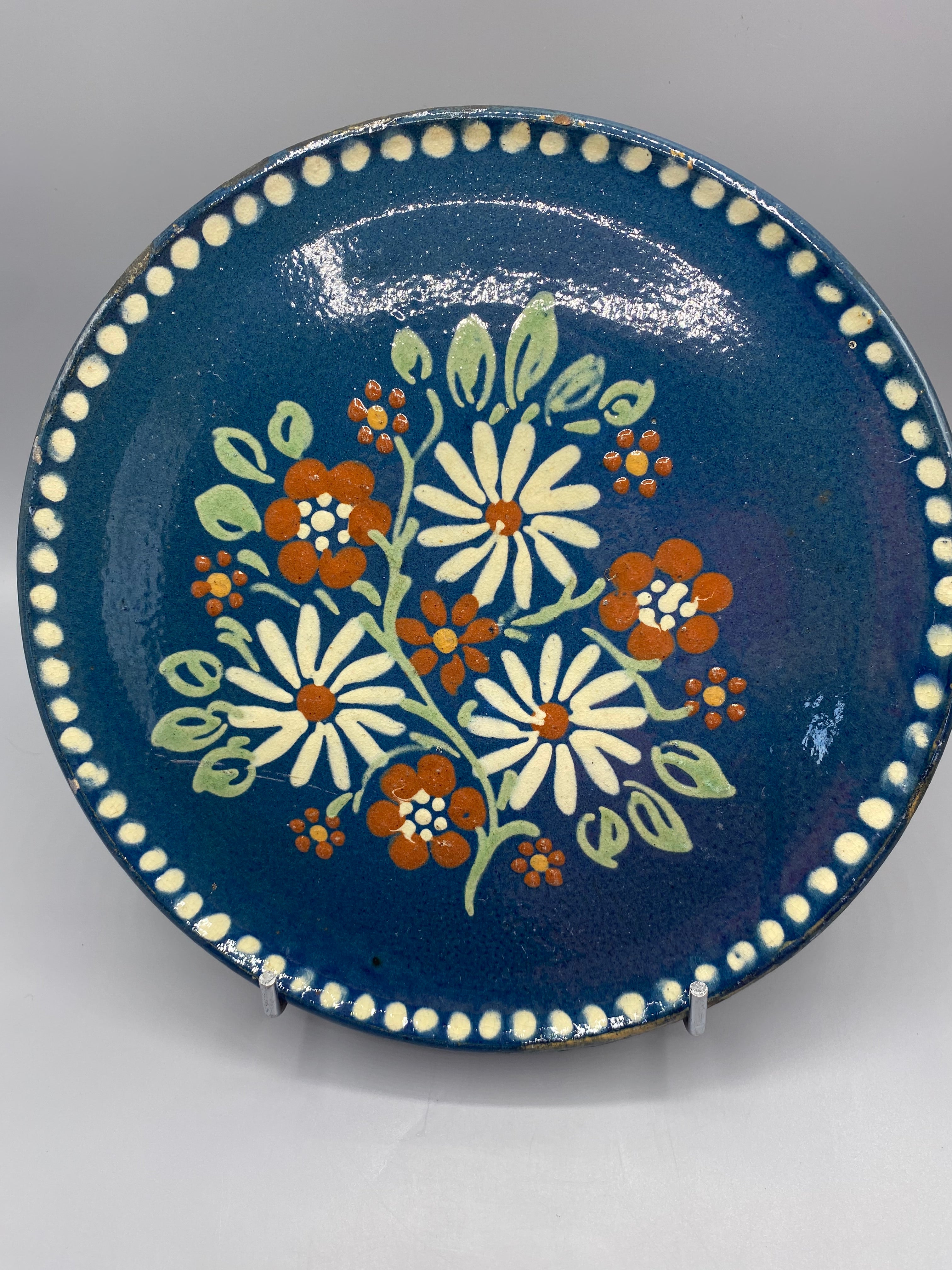 Grand plat mural céramique – vue de face, décor floral marguerites fond bleu profond