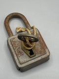 Cadenas ancien en acier avec sa clé reliée par une cordelette